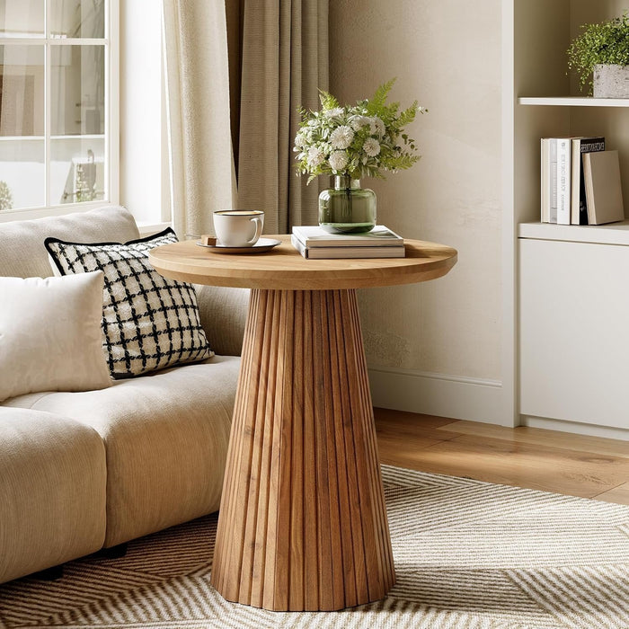 Rustic brown round pedestal side table beside a sofa#Color_Rustic Brown