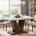 Farmhouse wooden dining table with pedestal base styled in a warm dining room