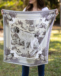 Person holding a large scarf with  a neutral bird dog  outdoors